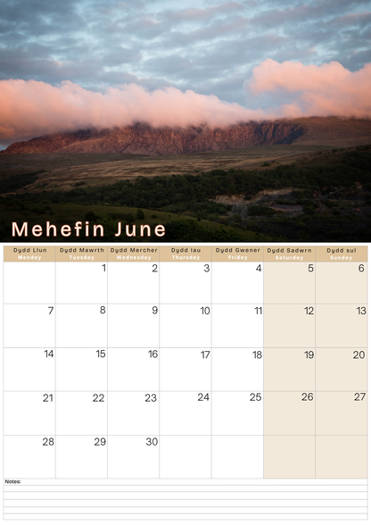 Calendar with a scenic mountain sunset landscape and the month 'Mehefin June' displayed.