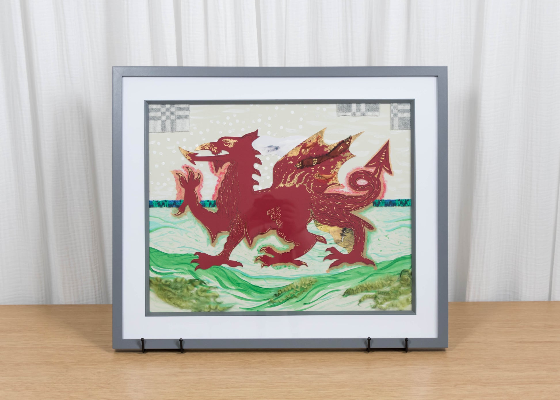 Framed mixed media artwork of a red dragon on a white and green background